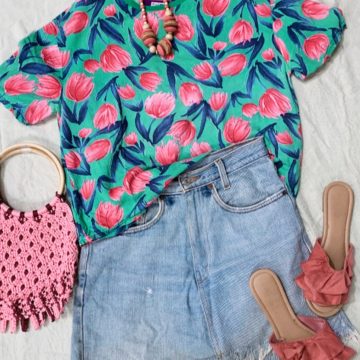 Teal and pink floral t-shirt with denim shorts, coral slides and pink woven bag