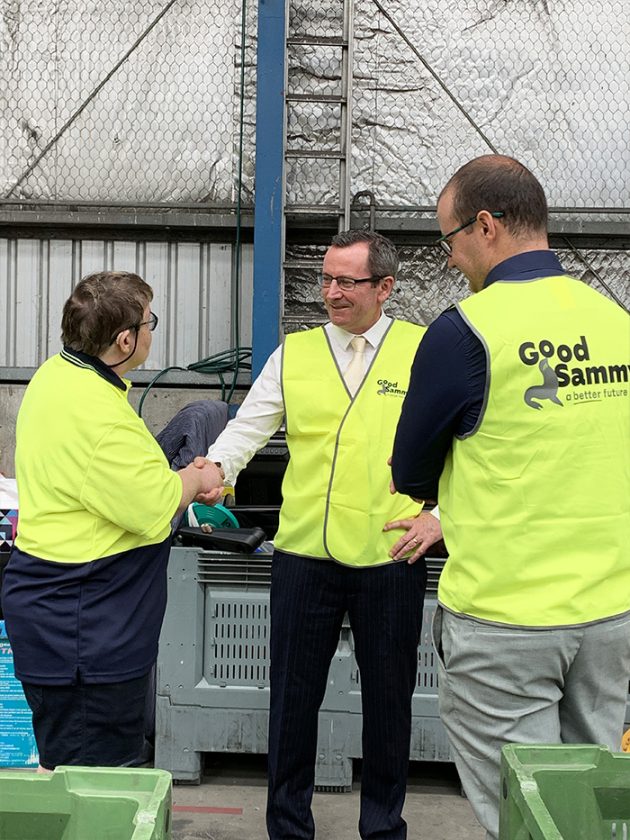 Good Sammy employee, Kelly, shaking the Premier's hand.
