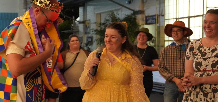 Good Sammy employee holding microphone at Disney-themed end of year awards