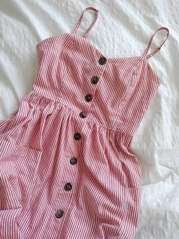red and and white dress with brown buttons down the front and skinny straps