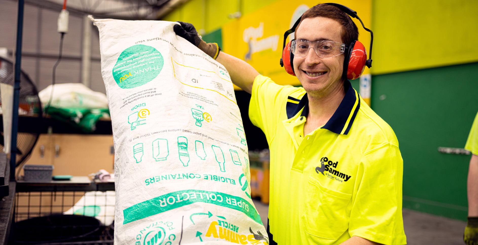 Man in Good Sammy uniform with Containers for Change bag