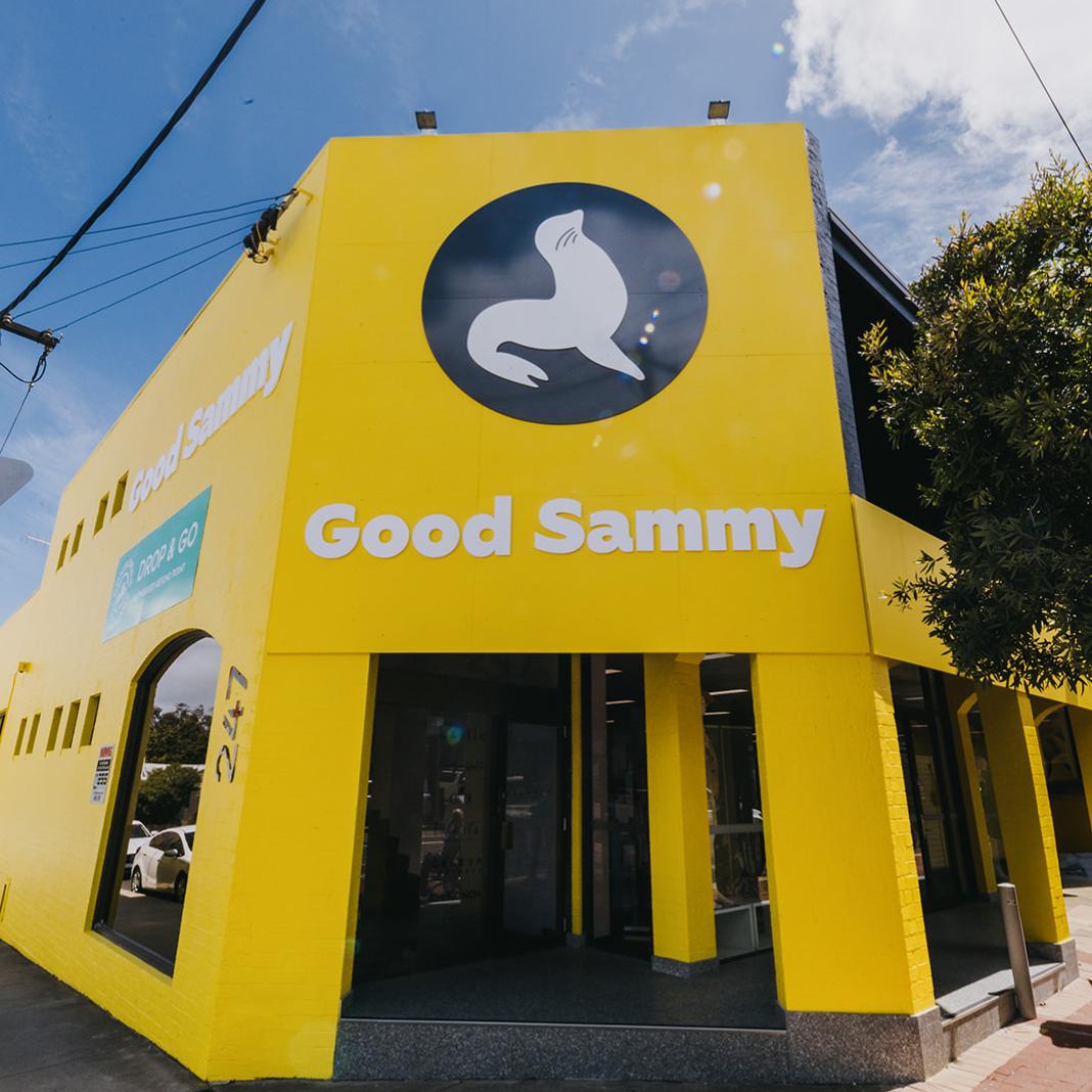 Image of a bright yellow building facade with the words Good Sammy under a large picture of a white seal on a dark grey background.